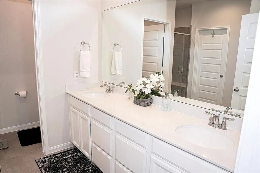 Vanity connecting the suite restroom and closet - 9829 Heritage Run Ln