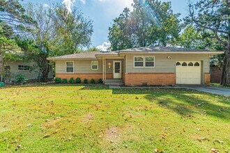 Building Photo - Three Bedroom Home in tree filled neighborhood! Lawn care included!