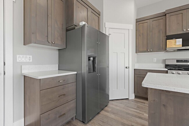 Building Photo - NEW HOME with large garage stalls and unfinished basement for additional storage