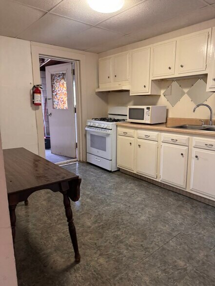 kitchen area with exit to an enclosed stairwell thaat leads to the parking lot - 13 Benton Ave