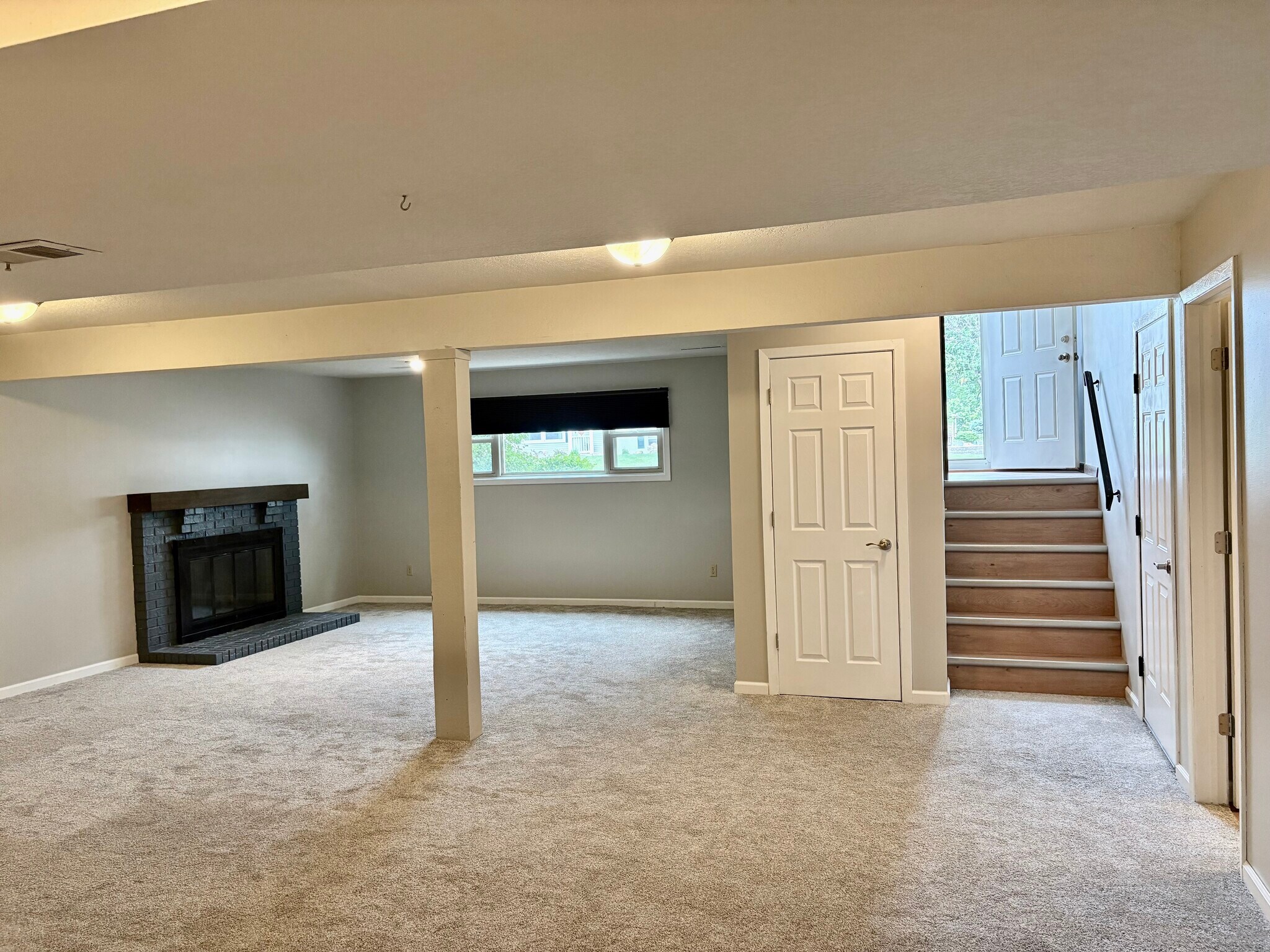 Fireplace in finished lower level with new carpet - 3885 Tam O Shanter Dr N