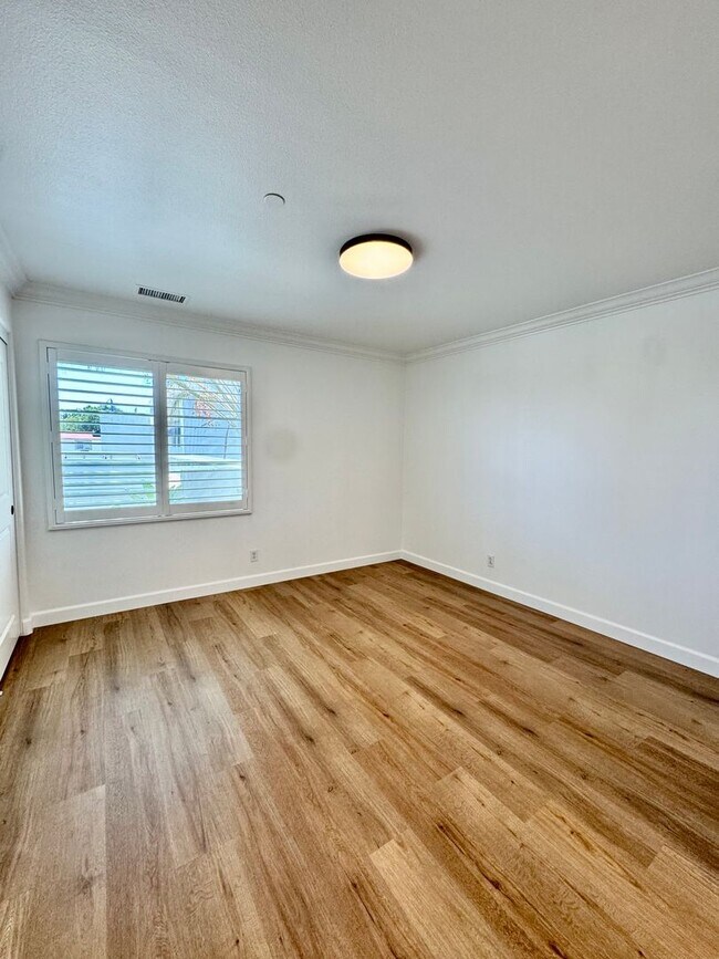 Building Photo - Beautifully Remodel Townhouse with AC & Two Car Garage!