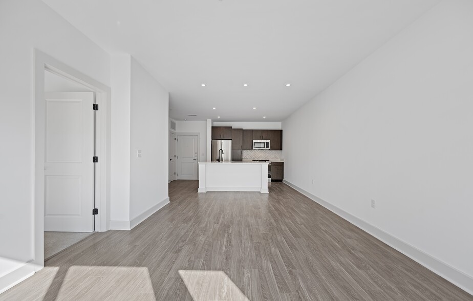 The long open layout keeps the living area visually connected to the kitchen. - The Landing at Vinnin Square