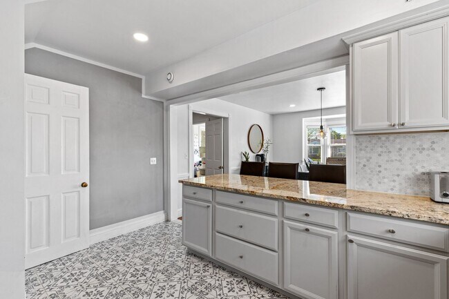 Building Photo - Luxurious Brick Colonial in Prestigious Gu...