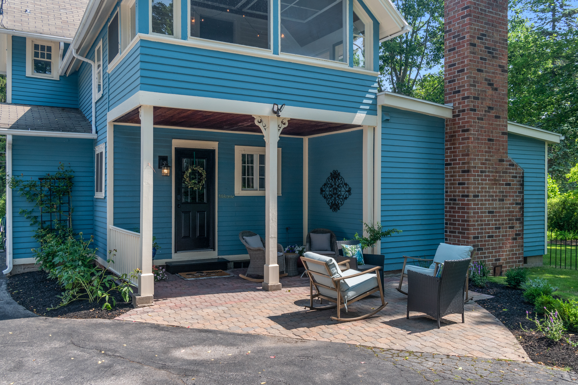 View of the 2nd floor porch with a pavered patio and outdoor furniture. - 5 W Jefferson Rd