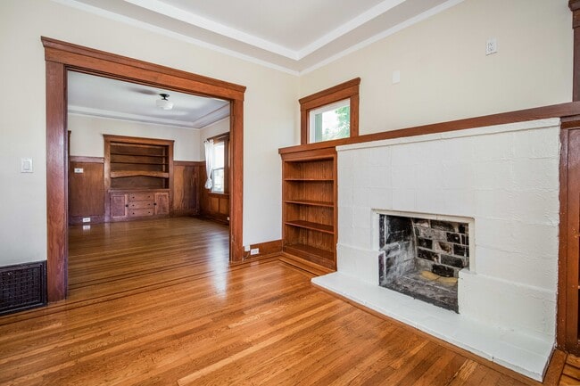 Living room with natural light, built ins, entry closet and security system. - 431 Athol Ave