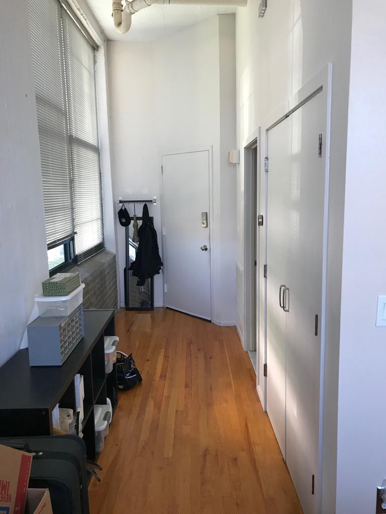 Long entryway with hooks and a shelf for keys and other items, as well as long bookcase and coat closet - 314 N. 12th Street