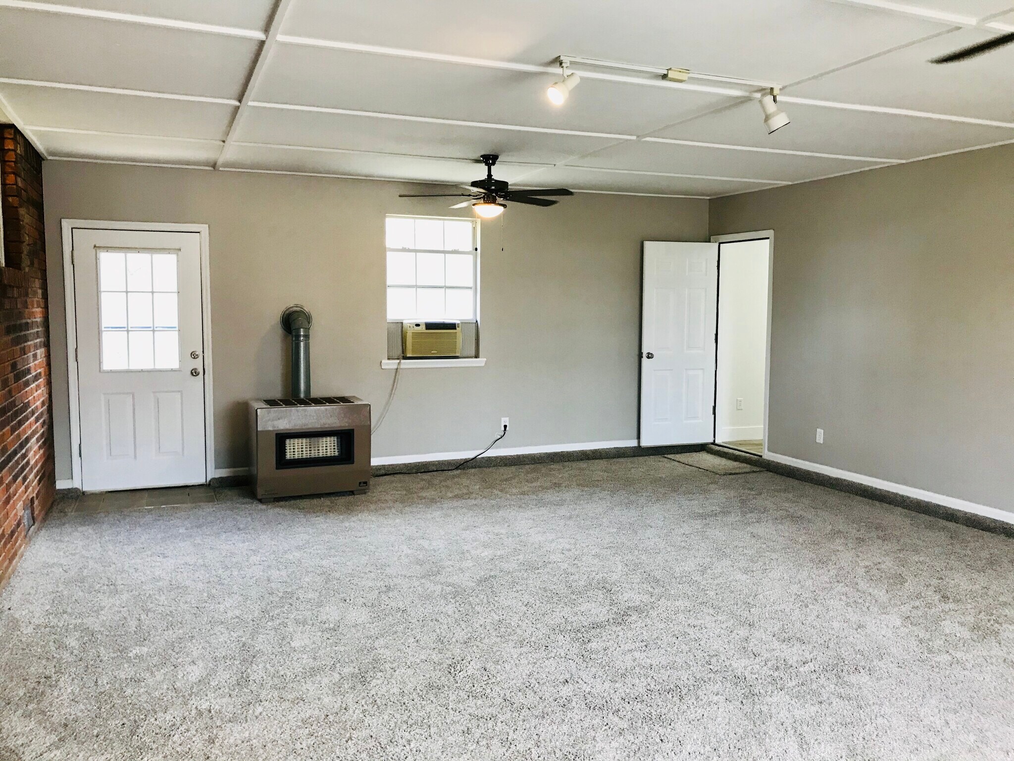 Den area with propane heater shown - 9225 Amos Rd