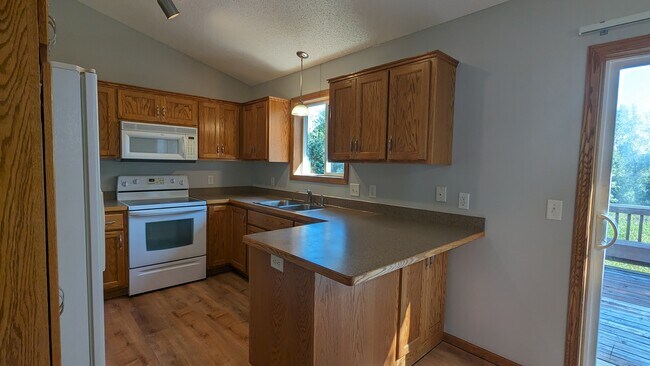 Beautiful oak kitchen cabinets with great storage space. - 758 Park Brook Rd NW