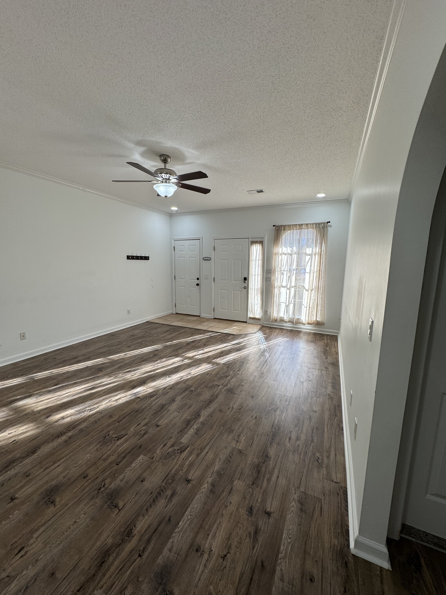 Living area with view of door to the garage to the left and front door on the right. - 1701 Water Oak Dr