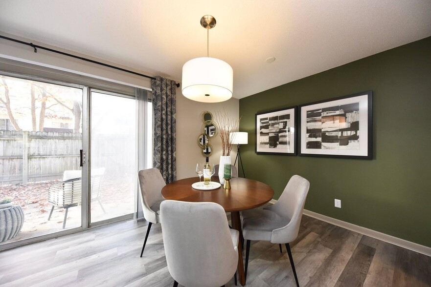 Dining area with hardwood-style flooring - Edison at Meridian Hills