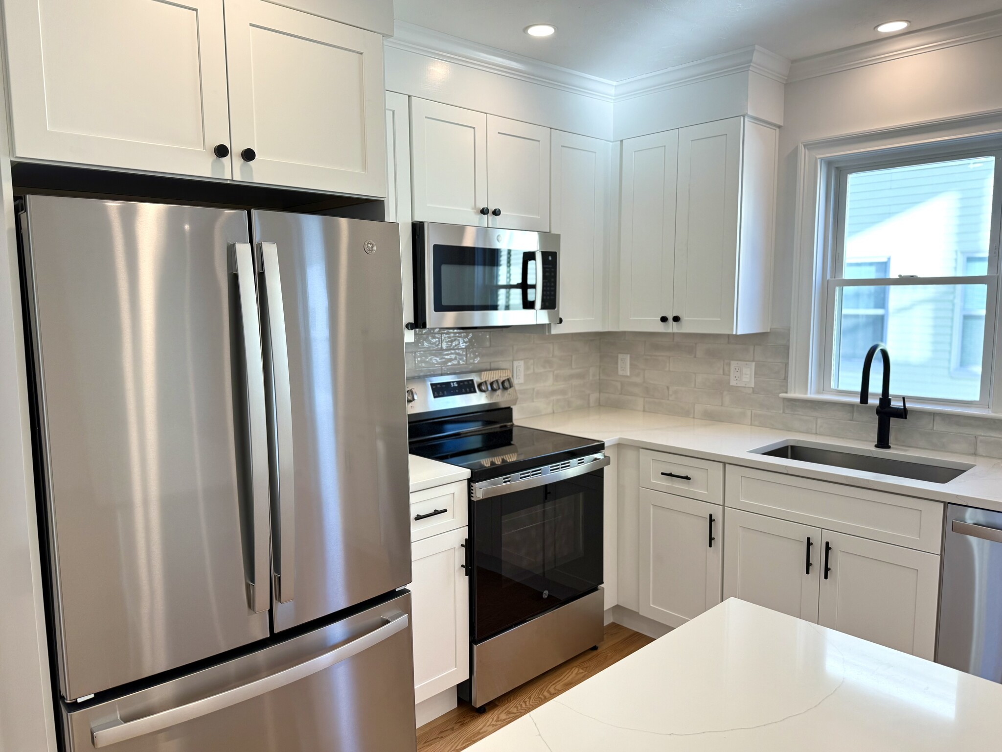 Kitchen: Brand New Stainless Steel Appliances, Quartz Countertops with Open Layout into Living Area - 34 Saint Joseph Ave