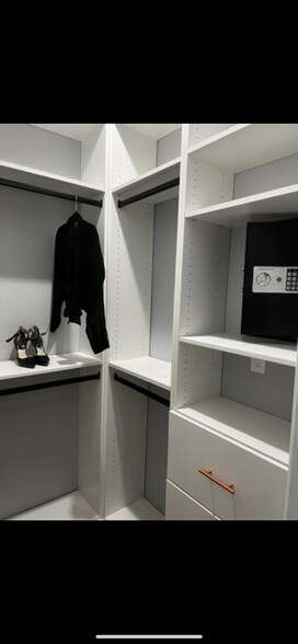 Master bedroom closet with built-in safe - 312 Poinsetta Dr