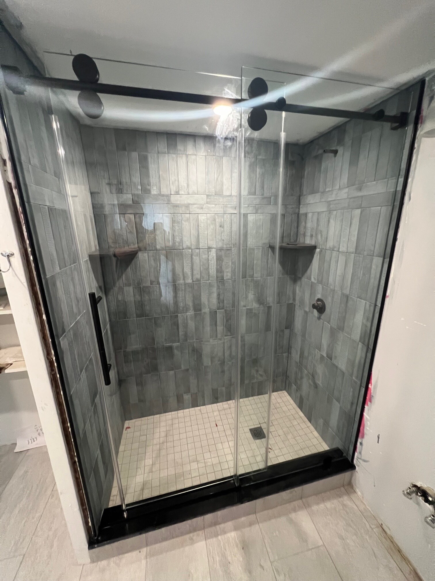 Walk in tiled shower with shelves and thick glass sliding door - 347 Elliot St