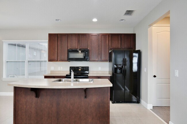 Building Photo - *Unfurnished* Beautiful 1/1 Spacious Garage Apartment in the Exclusive Laureate Park - Orlando!