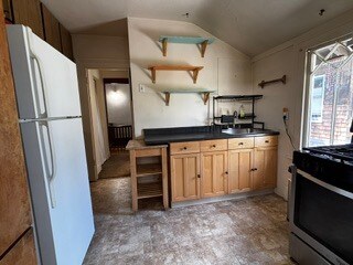 Kitchen sink, counter, and storage plus butcher block top rolling cart. - 2615 Parker St