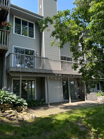 Back of unit showing walk out family room, deck off living room, and master bedroom window (top) - 2706 Mackubin St