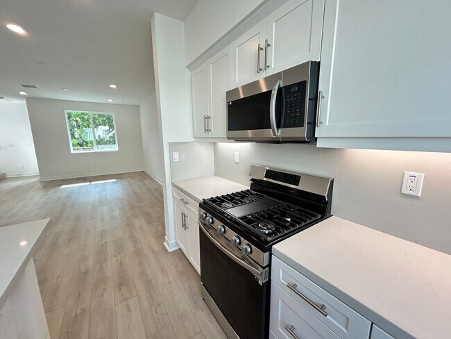 Building Photo - Gorgeous, 3 level townhome, featuring 2 car garage central Air, and in Unit laundry.