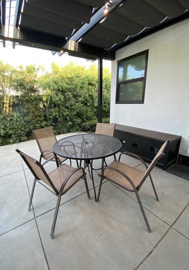 Shaded shared patio with retractable shaded sumbrella with pin lights - 3211 W Alameda Ave