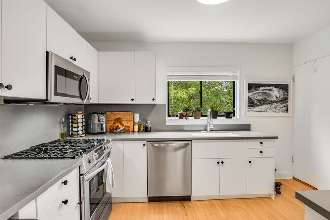 Large kitchen with stainless steel appliances and gas range - 96 Ardmore Pl NW