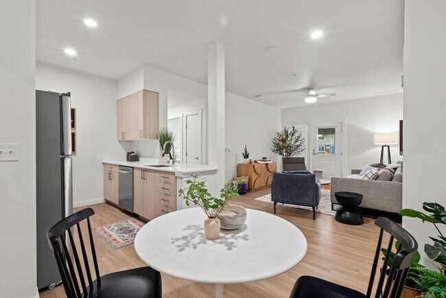 Indulge in the elegance of wood plank-style flooring, offering spacious rooms that effortlessly accommodate all your needs, including a dedicated dining area. - Modera Lacey