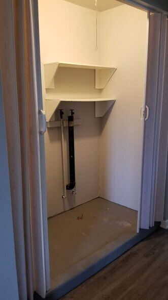 Laundry area neatly hidden away behind curtain. - 424 Waddell Ave