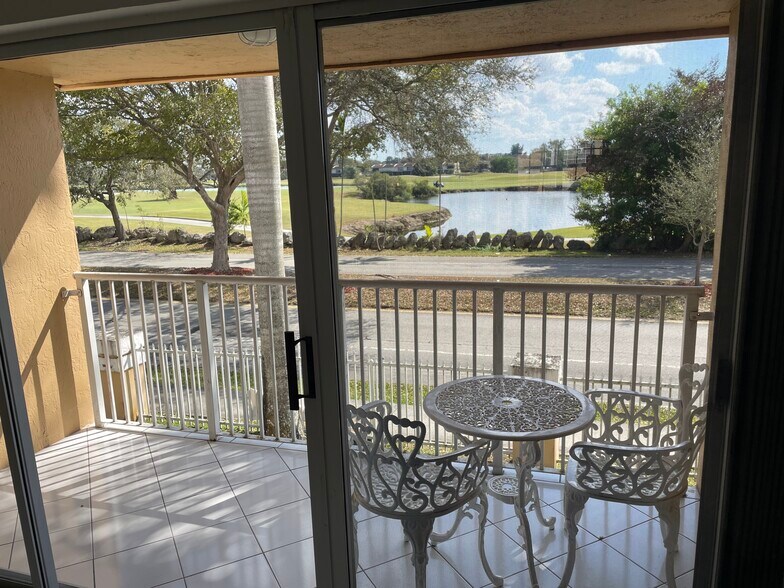 Kitchen / dining / living room view of golf course and lake - 14260 SW 57th Ln