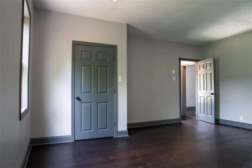 Reverse view of primary bedroom with walk in closet - 1120 Brabec St