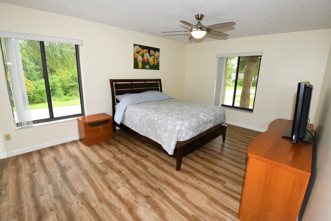 Spacious master suite with contemporary furniture and large walk-in closet. - 1935 Silver Pine SW Way