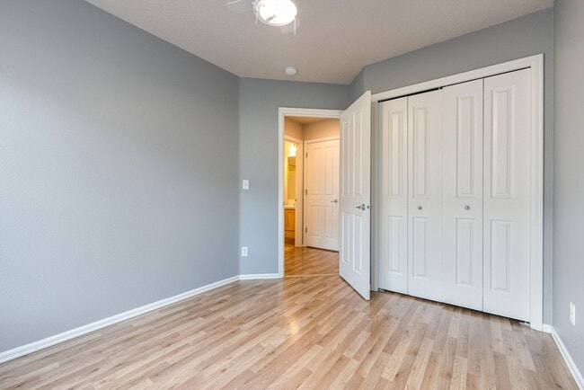 Building Photo - Lovely and bright townhouse with a hard wood flooring throughout, a 2 car garage, AC & more!