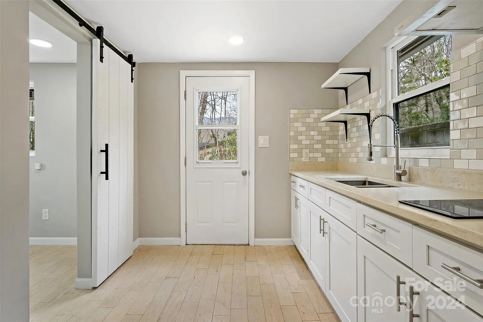 Kitchen looking towards porch and bedroom doors. - 228 Barrett Rd