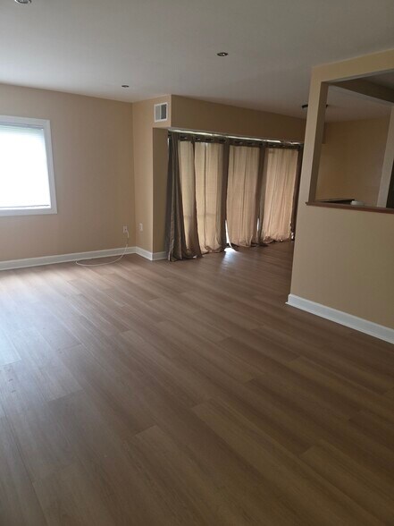 Dining room with laminated wood flooring - 6300 Hil Mar Dr