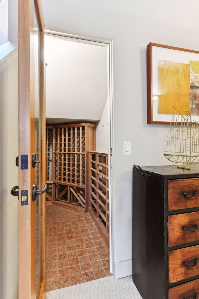 Wine storage discreetly tucked under the stairs - 745 Rice St E