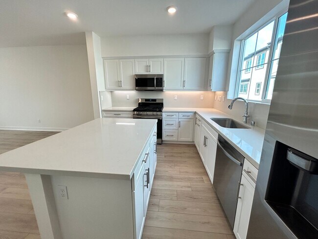 Building Photo - Gorgeous, 3 level townhome, featuring 2 car garage central Air, and in Unit laundry.