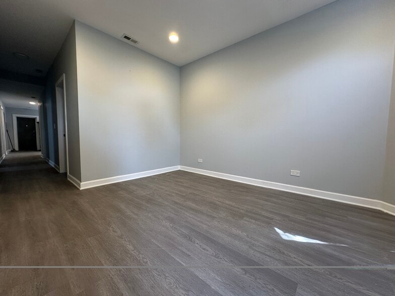 Large living room with fresh paint and brand-new flooring throughout - 5653 S May St