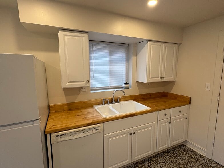Original cast iron sink paired with butcher block countertops - 6035 Oakwood Ave