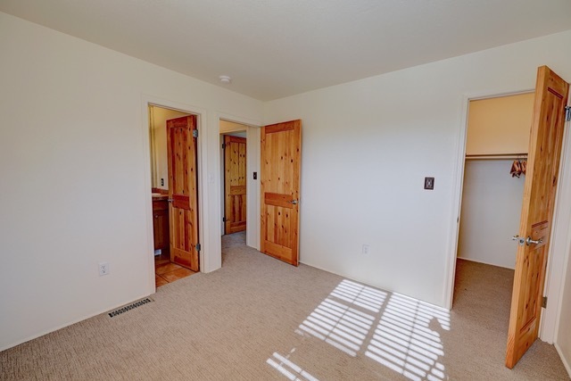 Unit 1011--Bedroom 1 with adjoining bath and walk in closet - 2210 Miguel Chavez Rd