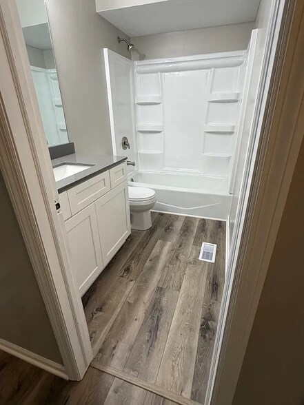 Primary bathroom with new vanity, sink, quartz countertop, faucets, toilet, and shower - 6718 S 87th St