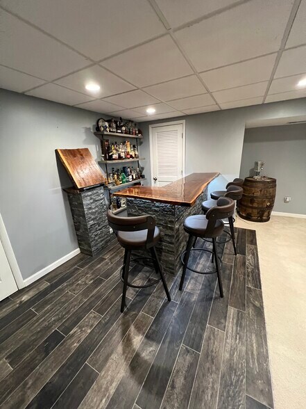 Bar to the right when you walk down the steps. Dry bar with fridge built in - 8804 Spruce Mill Dr