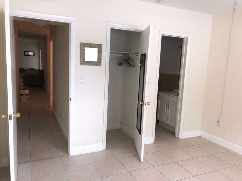 view of master closet and door into bathroom - 265 SW 7th St