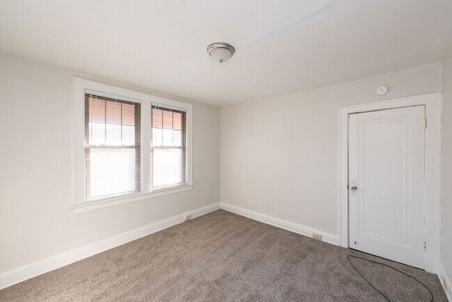 Building Photo - Beautifully updated Tudor style duplex. Up...
