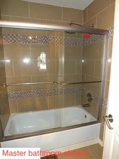Master Bath Shower with custom tiles and glass shower door - 11809 Rockaway Ln