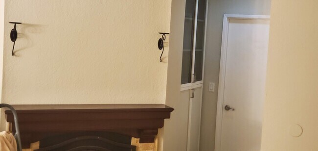 Fireplace & hallway storage leading to bedroom & bathroom doors - 2852 C St