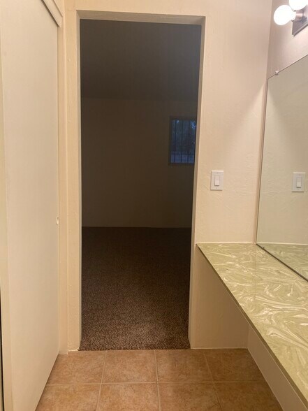 powder room off of master and bathroom with closets behind - 7856 E Linden Pl