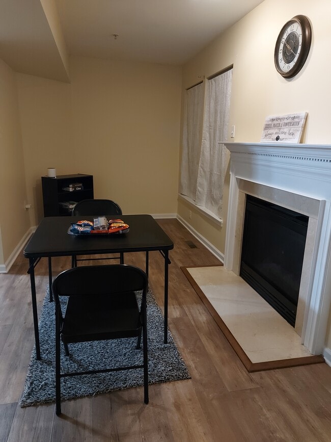 Game area with a decorative fire place - 7021 Holly Springs Ln