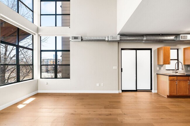 Building Photo - Modern 2BD, 1.5BA Condo with 20' Ceilings and Garage Parking Spot