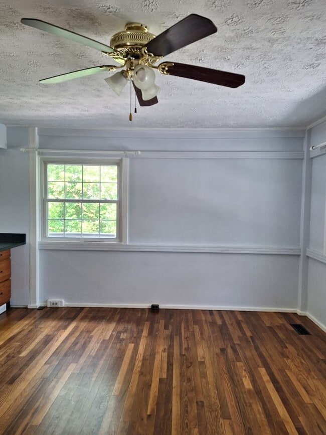 Building Photo - Cute white cottage with white picket fence & Huge deck off back door!