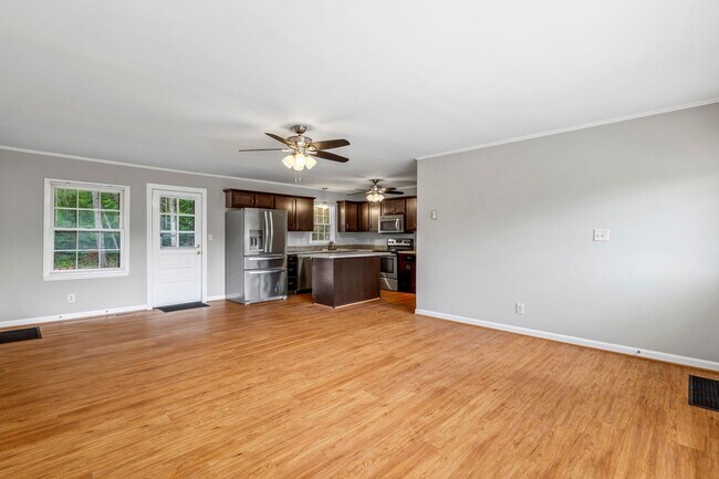 Building Photo - Updated Home, Stainless Steel Appliances, Wood Like Flooring, Deck, Garage!