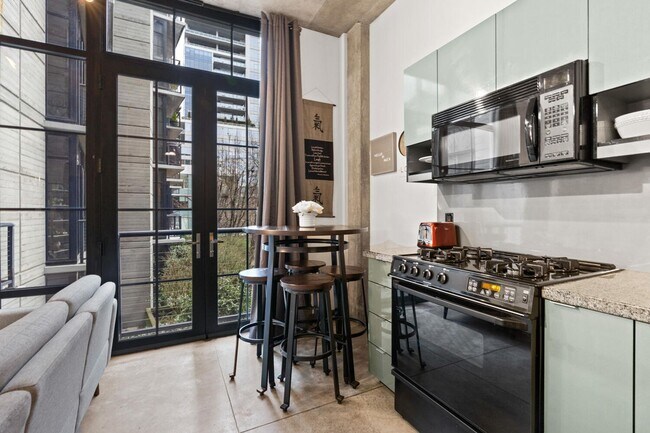 Building Photo - **FURNISHED** Streetcar Lofts studio w/parking/storage/Juliette balcony/fitness center/courtyard ...