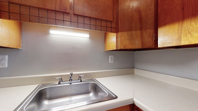 Explore this efficient kitchen design, combining functionality with a warm, inviting ambiance. - Harmony Apartments